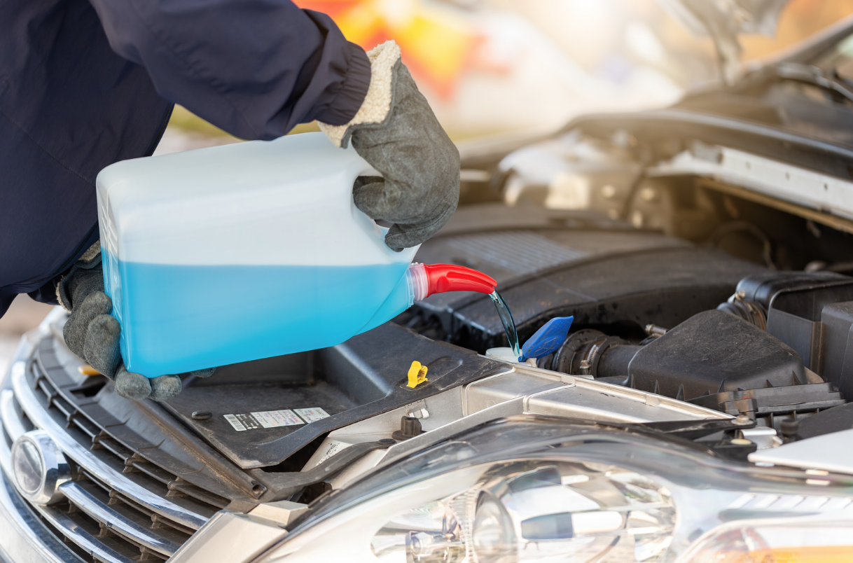 Gloved person filling van water tank