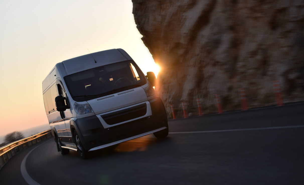 Van driving round mountain road bend